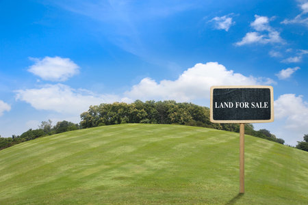 Building land for new construction project on green meadow, plot for construction area. real estate sale or property investment concept, Buying new home for family.の写真素材