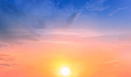 Beautiful sky painted by the sun leaving bright golden shades.Dense clouds in twilight sky in winter evening.Image of cloud sky on evening time.Evening sky scene with golden light from the setting sunの写真素材