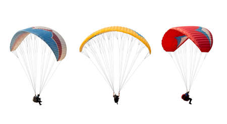 collection Bright colorful parachute isolated on white background,  The sportsman flying on a paraglider. Concept of extreme sport, taking adventure challenge.の写真素材