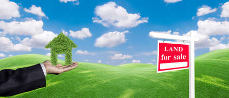 Panorama house symbol and land For Sale signboard on the meadow under clear sky in real estate sale or property investment concept, Buying new home for family.の写真素材