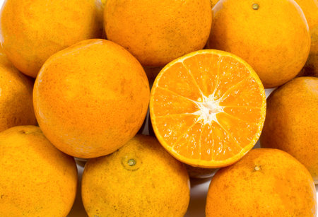 Closeup of sliced ââoranges in the market.Top view of freshly harvested fruit of an orange tree with organic orange green leaves.の写真素材