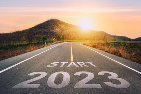 new year 2023 or start concept.word match 2023 words and strategy written on asphalt road in sunset concept of goals and challenges or career path success business opportunity and change.の写真素材