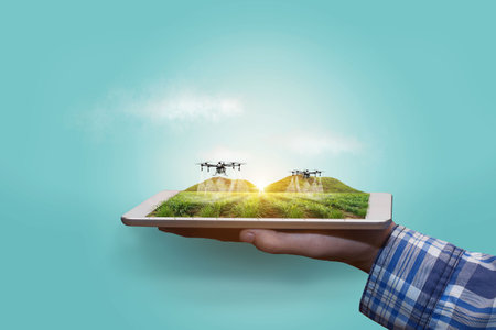 Agriculture drone fly to sprayed fertilizer on the Sugarcane fields. smart farmer use drone for various fields like research analysis, terrain scanning technology, smart technology concept.の写真素材