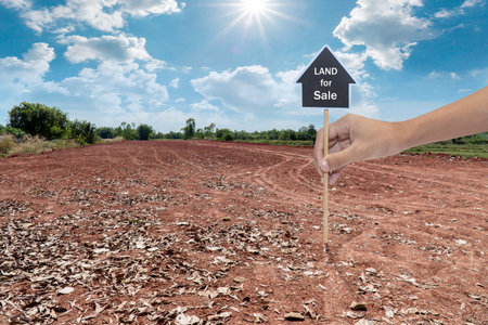 House symbol with location pin and Empty dry cracked swamp reclamation soil, land plot for housing construction project with and beautiful sunset sky with fresh air Land for sales landscape conceptの写真素材