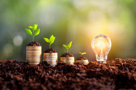 Growing Money - Plants on Coins - Money and Investment Concepts. growing money in soil, success, Creative light bulb idea, power energy or business idea concept ecology, loan, mortgage,の写真素材