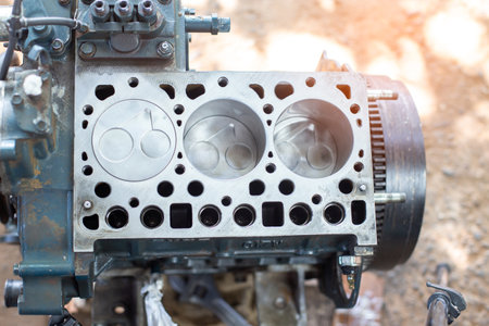 Engine cylinder head lying on a table in a car service. Maintenance the engine and replace engine...