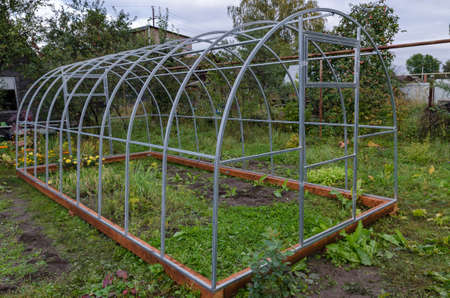 Manufacturer of greenhouses for vegetable garden with his own handsの写真素材