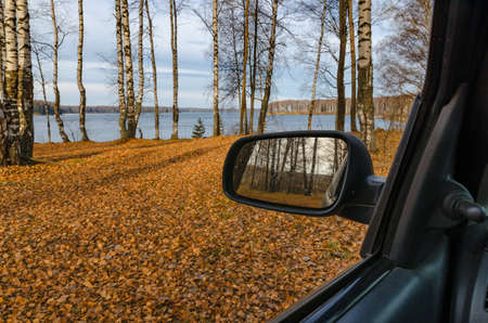 The reflection in the rear view mirror of the car on the natureの写真素材