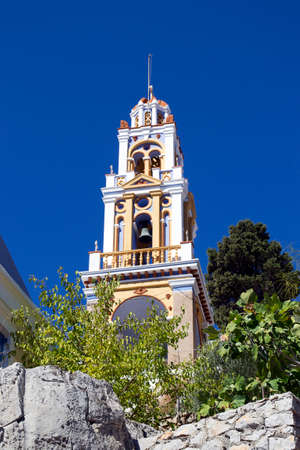 Church tower on the blue sky. The island of Symi. Greeceの写真素材