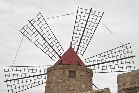 Old windmill on the salines near trapaniの写真素材
