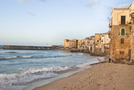 beach of Cefalu with centre city in the background. Sicilyの写真素材