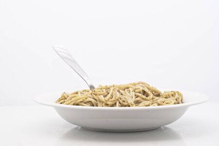Spaghetti with pesto isolated on white backgroundの写真素材