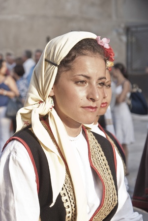 POLIZZI GENEROSA, SICILY - AUGUST 19: Beautiful Women of Bosnia folk group and sicilian men at the International "Festival of hazelnuts": August 19, 2012 in Polizzi Generosa,Sicily, Italyのeditorial素材