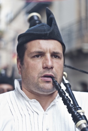 POLIZZI GENEROSA, SICILY - AUGUST 19:Spanish man playing bagpipes at the International Festival of...