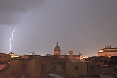 lightning over urban houses in Palemo, Sicily, Italyの写真素材