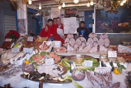 PALERMO - DECEMBER 22: men selling fish on the local market in Palermo, called Ballaro. This market is also tourist attraction in Palermo, Sicily, Italy on Dec. 22, 2012.のeditorial素材