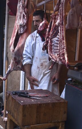 PALERMO - DECEMBER 29: butcher sells meat on the local market in Palermo, called Ballaro. This market is also tourist attraction in Palermo, Sicily, Italy on Dec. 29, 2012.のeditorial素材