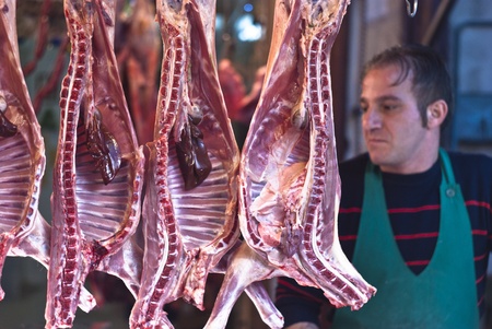PALERMO - DECEMBER 29: butcher sells meat on the local market in Palermo, called Ballaro. This market is also tourist attraction in Palermo, Sicily, Italy on Dec. 29, 2012.のeditorial素材