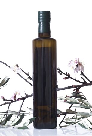 olive branch and a bottle of olive oil isolated on white backgroundの写真素材
