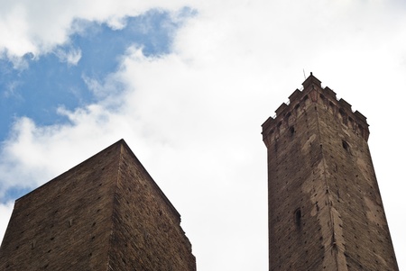 Due Torri - symbol of city under cloudy sky in Bologna, Italyの写真素材