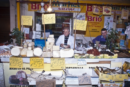 PALERMO - DECEMBER 22: men selling cheese on the local market in Palermo, called Ballaro. This market is also tourist attraction in Palermo, Sicily, Italy on Dec. 22, 2012.のeditorial素材