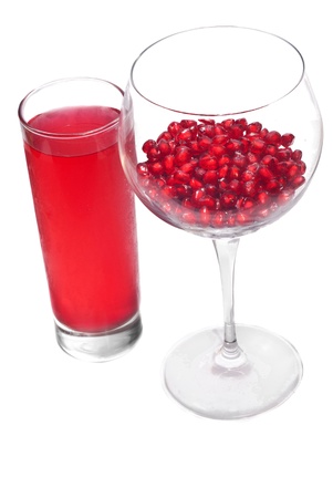 fresh grains and juice pomegranate in glass isolated on white backgroundの写真素材