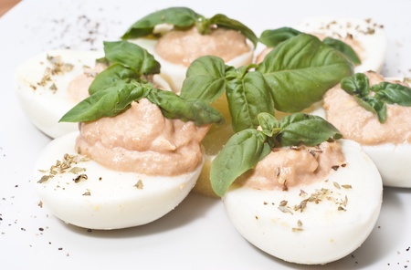 eggs with tuna sauce and basil on wooden boardの写真素材