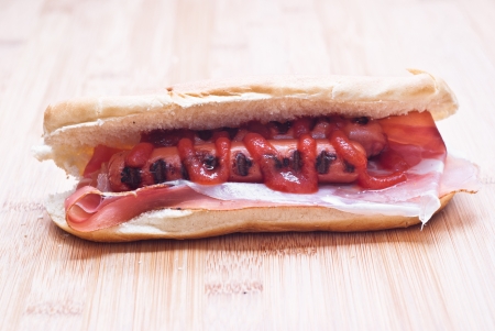 Appetizing hot dog on wooden boardの写真素材