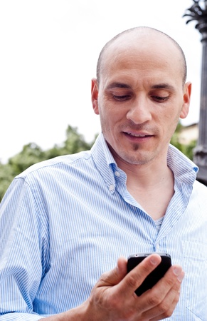 Portrait of a handsome businessman talking on cellphone outdoorsの写真素材
