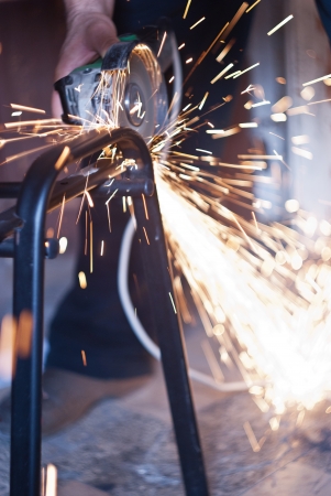 Worker cutting metal using angular grinding machineの写真素材