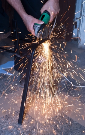 Worker cutting metal using angular grinding machineの写真素材