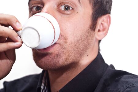 Close up portrait of a businessman drinking coffee isolatrd on whiteの写真素材