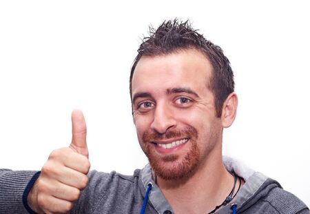 Portrait Of A Happy Young Man Showing Thumb Up Sign Isolated On White Backgroundの写真素材