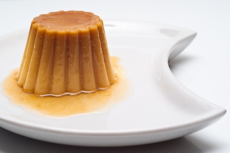 Delicious yogurt pudding with caramel isolated on  a white background