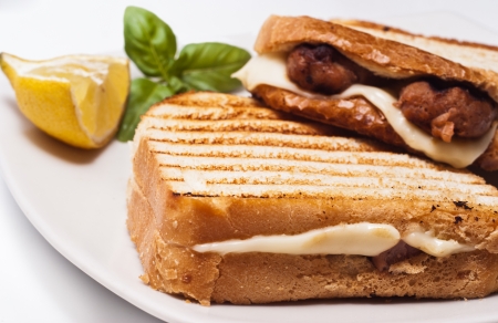 sandwich with some grilled sausages and cheeseの写真素材