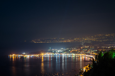 Night view from Taormina with Etna volcanoの写真素材