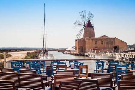 bar with a view of the harbor of Marsala to the island of mozia. Sicily, Italyのeditorial素材
