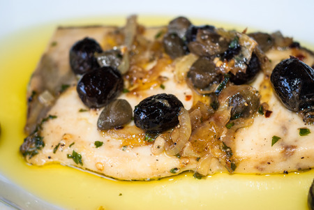Delicious swordfish with sweet and sour onions and olives. Italian recipeの写真素材