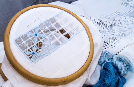 The embroidery hoop with canvas and sewing threads on table close upの写真素材