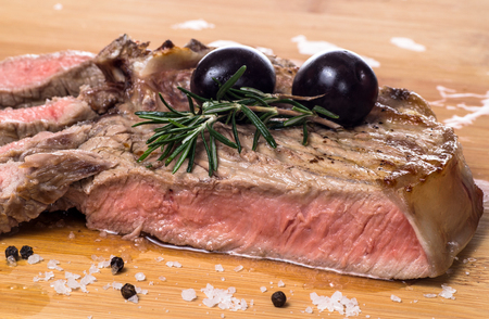 Grilled fiorentina steak with rosemarine and olive. Closeupの写真素材