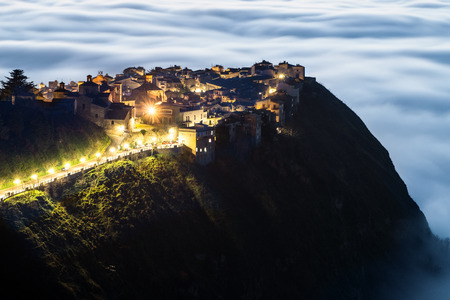 A particularly attractive view of the Sicilian town, Polizzi Generosa when low cloud (the so-called maretta) collects around the foot of the mountainsの写真素材
