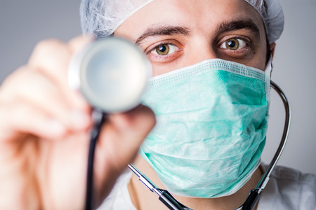 Young confident and friendly doctor in medical officeの写真素材