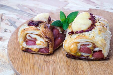 Delicious italian snack with puff pastry on wooden boardの写真素材