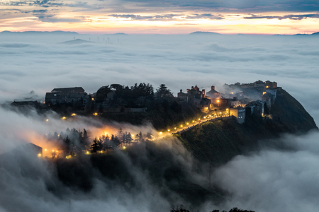 A particularly attractive view of the Sicilian town, Polizzi Generosa when low cloud (the so-called maretta) collects around the foot of the mountainsの写真素材