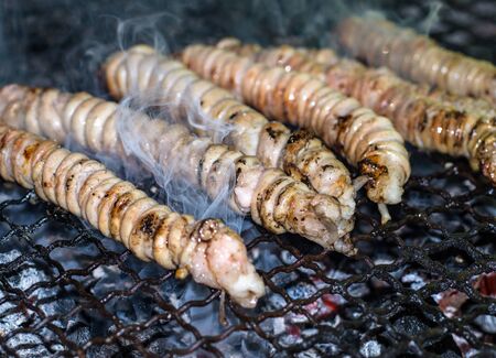 Stigghiole -typical street food in Palermo. lamb, goat or pork bowels flavored with onions and parsley and grilled over coalsの写真素材