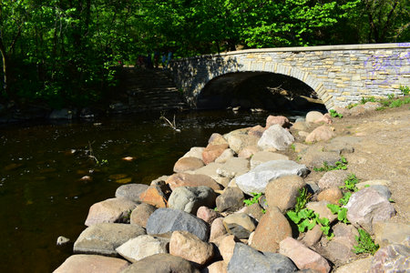 Stone bridge over the river in the city park. Spring landscape.の写真素材