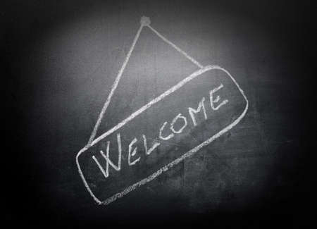 Word "Welcome" written by a chalk on a blackboardの写真素材