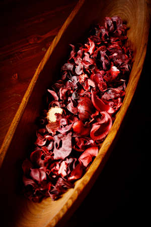 bowl of potpourri  on dark wooden tableの写真素材