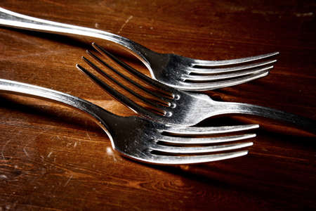 old used cutlery  on dark wooden tableの写真素材
