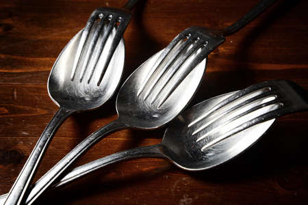 old used cutlery  on dark wooden table